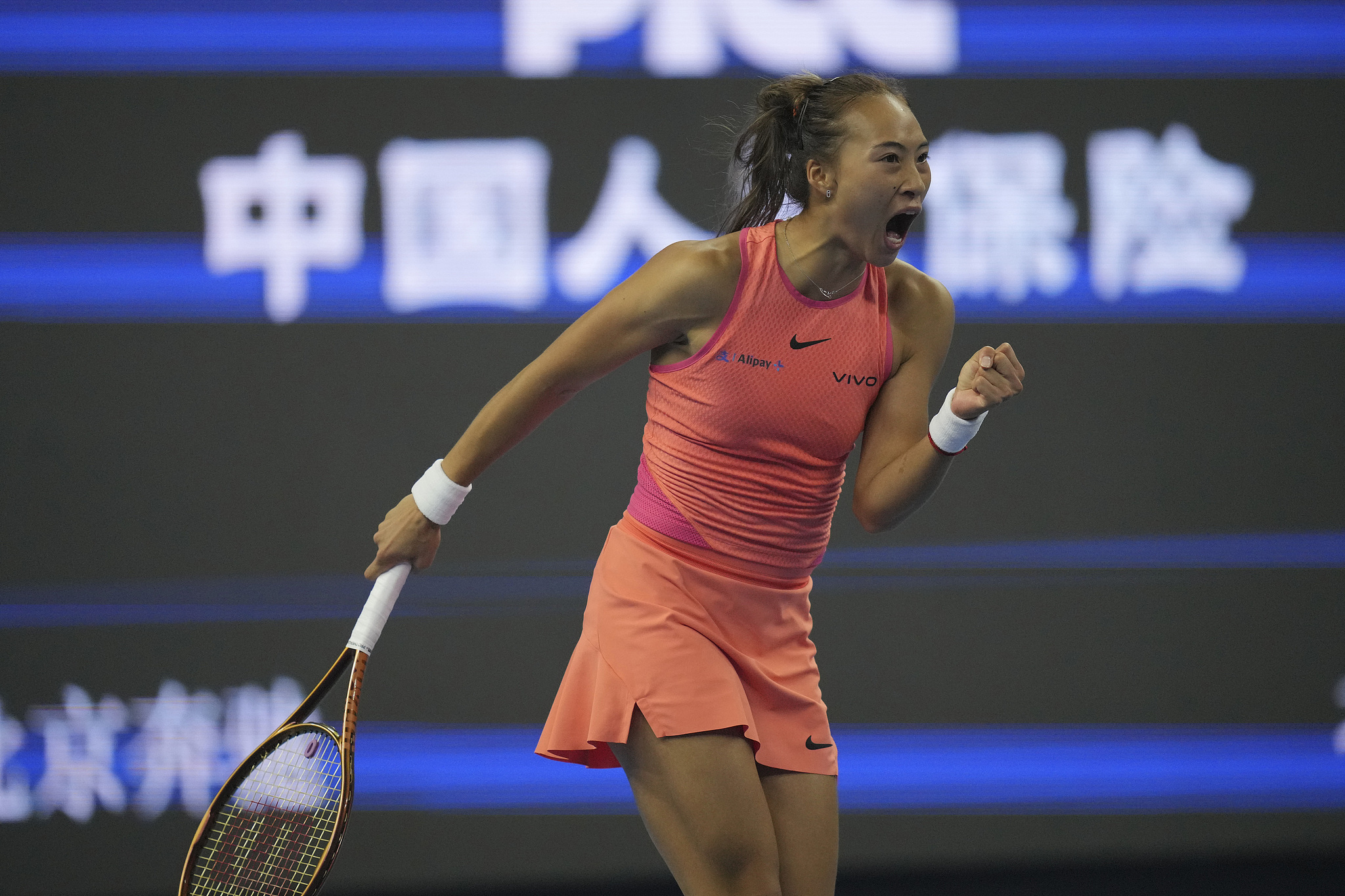 Zheng Qinwen of China reacts after hitting a shot against Mirra Andreeva of Russia in the women's singles quarterfinals at the China Open in Beijing, October 4, 2024. /CFP