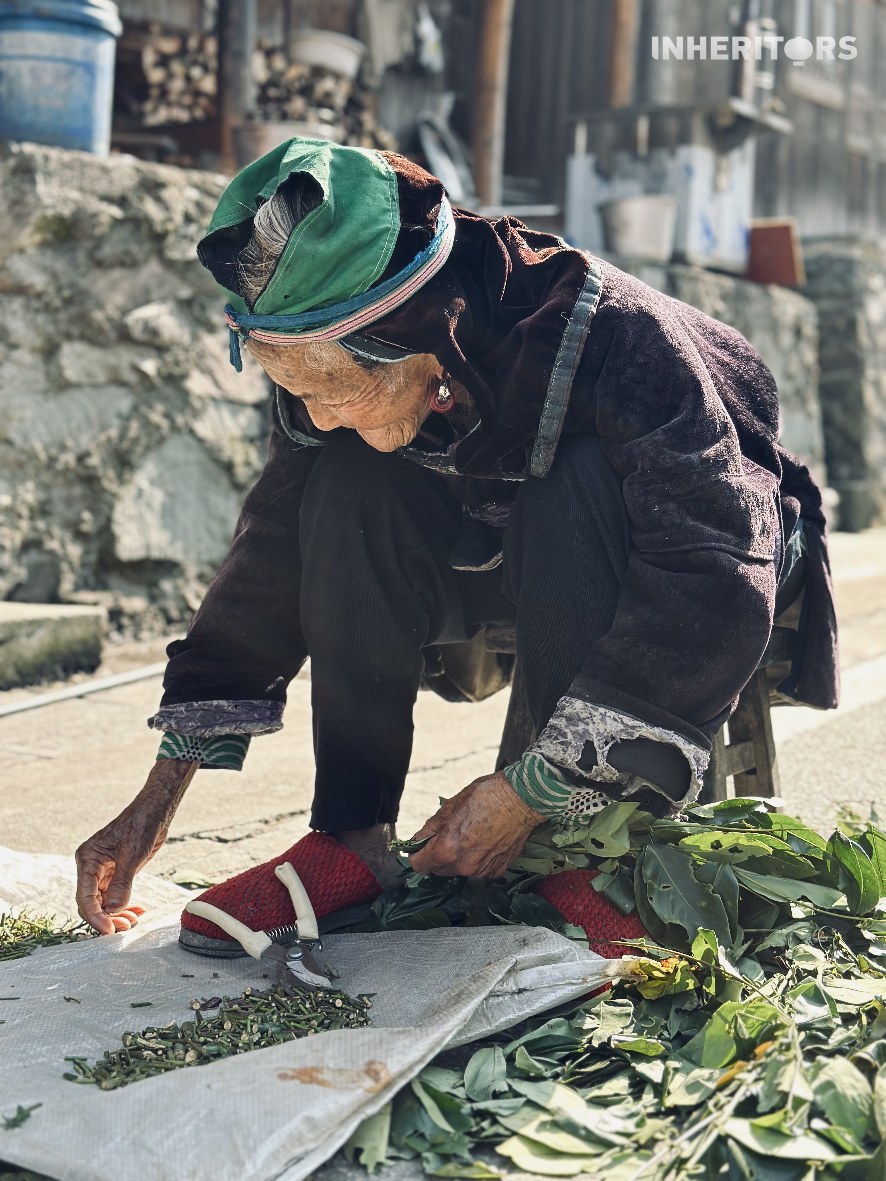 A woman from the Dong ethnic group prepares dyestuff for traditional cloth at a village in southwest China's Guizhou Province. /CGTN 