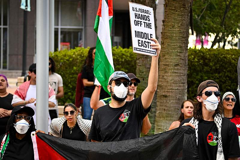 Pro-Palestinian protesters hold signs as people rally in support of Gaza and Lebanon in front of the City Hall to mark one year of the war between Hamas and Israel in Orlando, Florida, October 5, 2024. /CFP