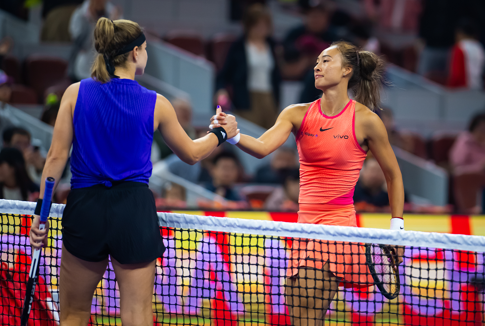 Zheng Qinwen (R) of China and Karolina Muchova of the Czech Republic shake hands at the net after their semifinal at China Open in Beijing, China, October 5, 2024. /CFP