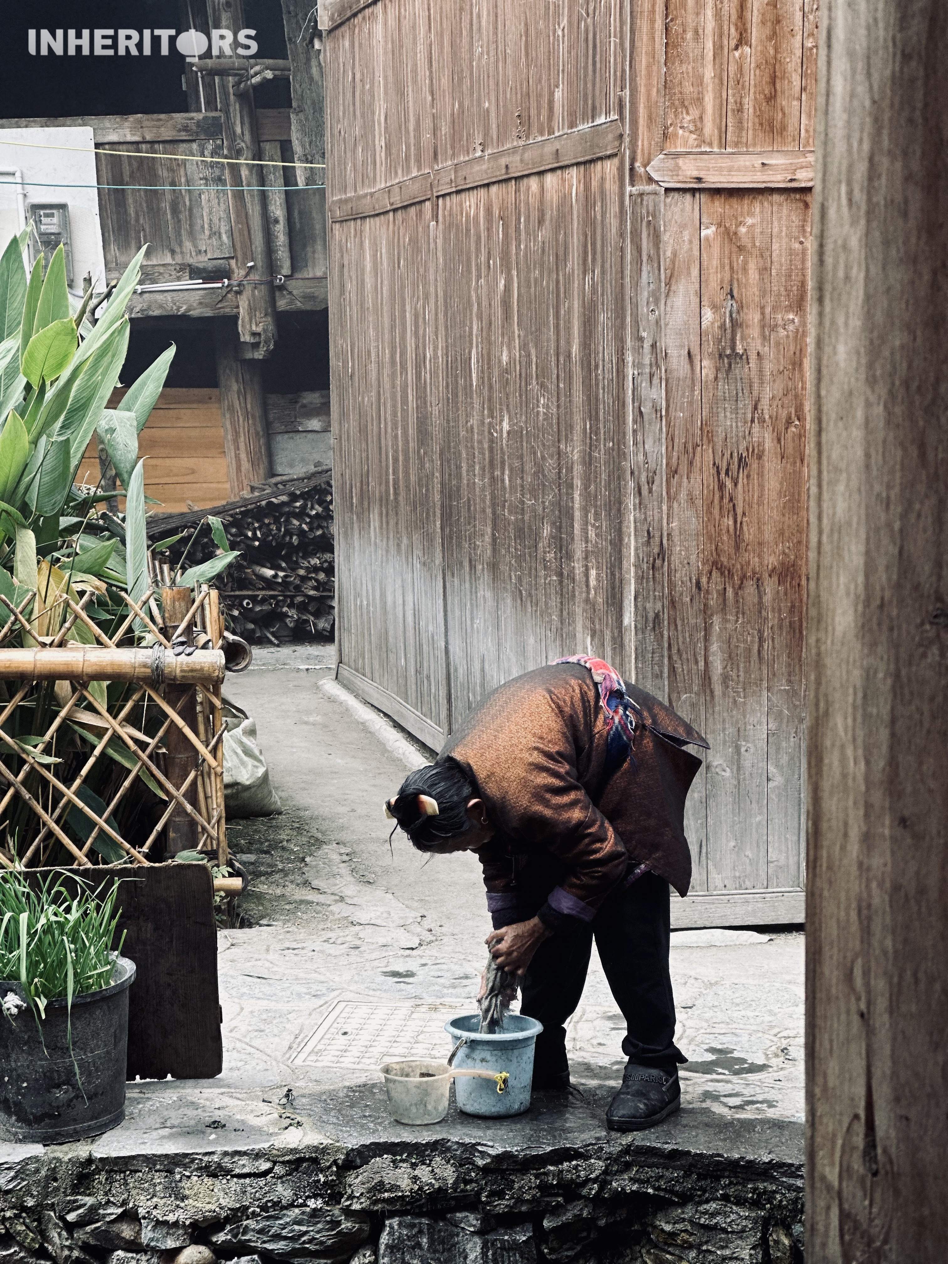 A woman washes a piece of cloth at a Dong village in southwest China's Guizhou Province. /CGTN