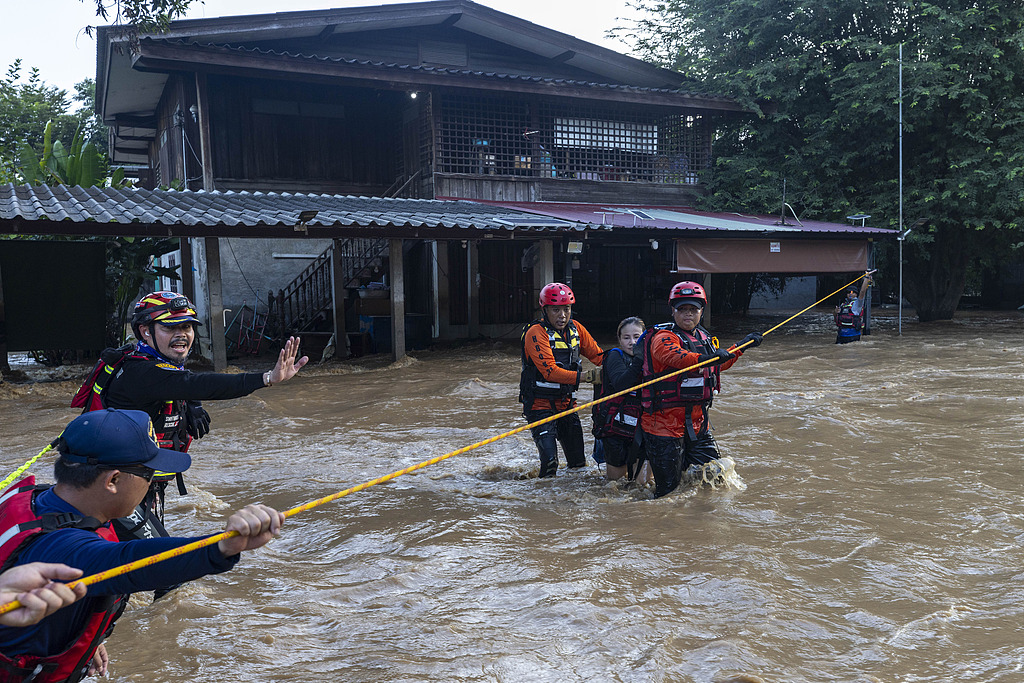 Thai rescuers help a woman from a flood-hit area in Chiang Mai province, Thailand, October 6, 2024. /CFP