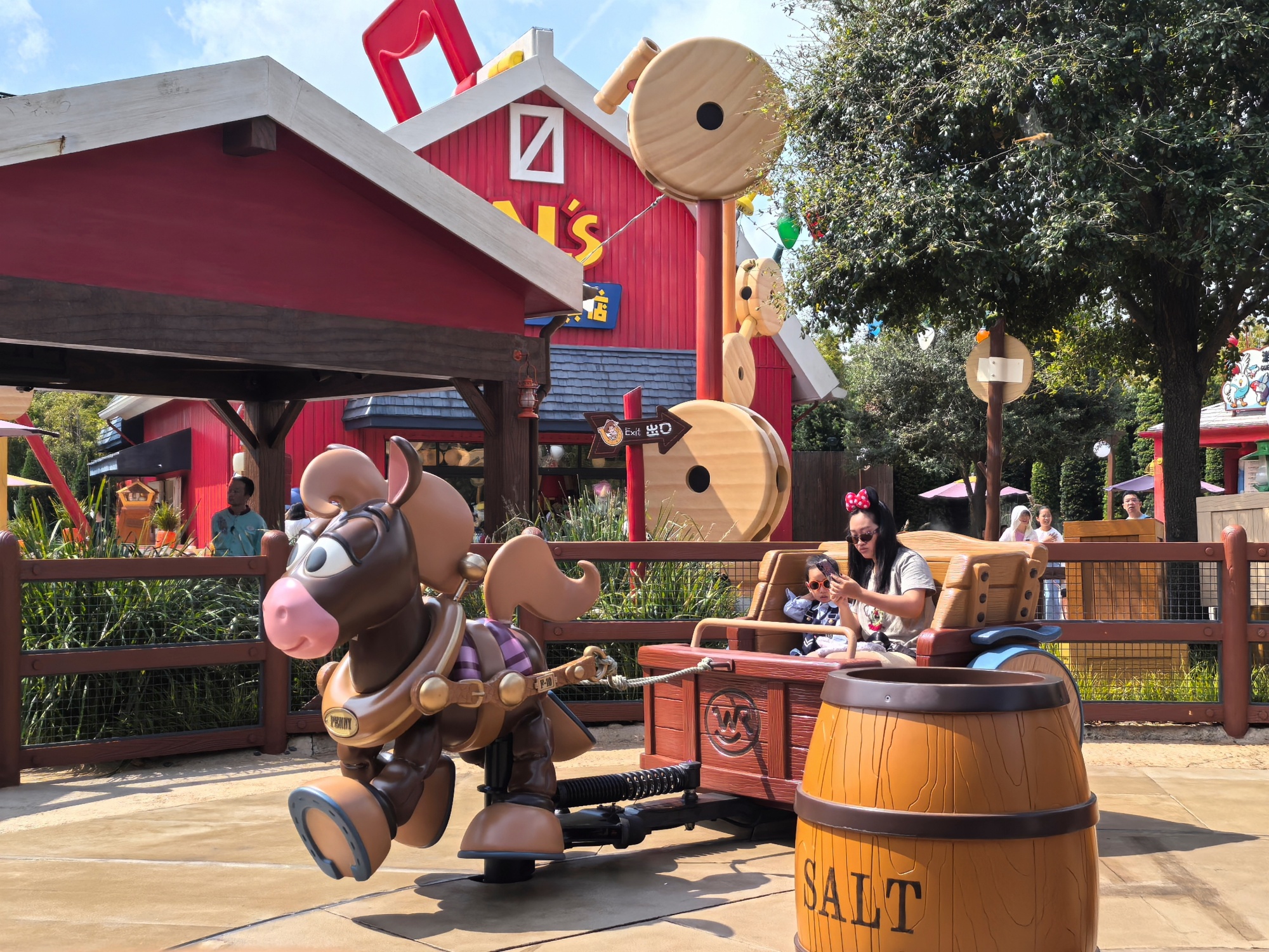 Tourists take a ride at Toy Story Land in Shanghai Disneyland on September 30, 2024. /CGTN