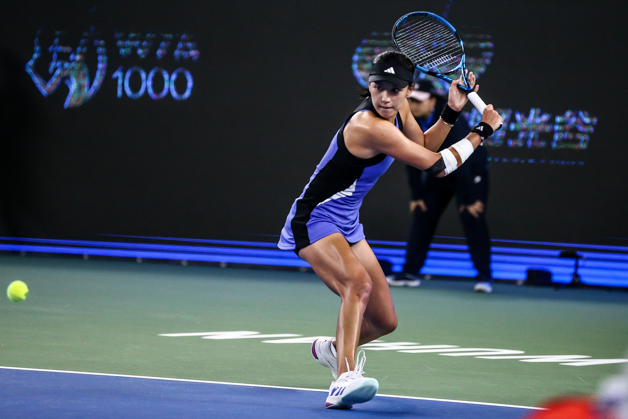 Wang Xinyu of China hits a shot in the women's singles match against Caroline Dolehide of the U.S. at the Wuhan Open in Wuhan, central China's Hubei Province, October 7, 2024. /CFP