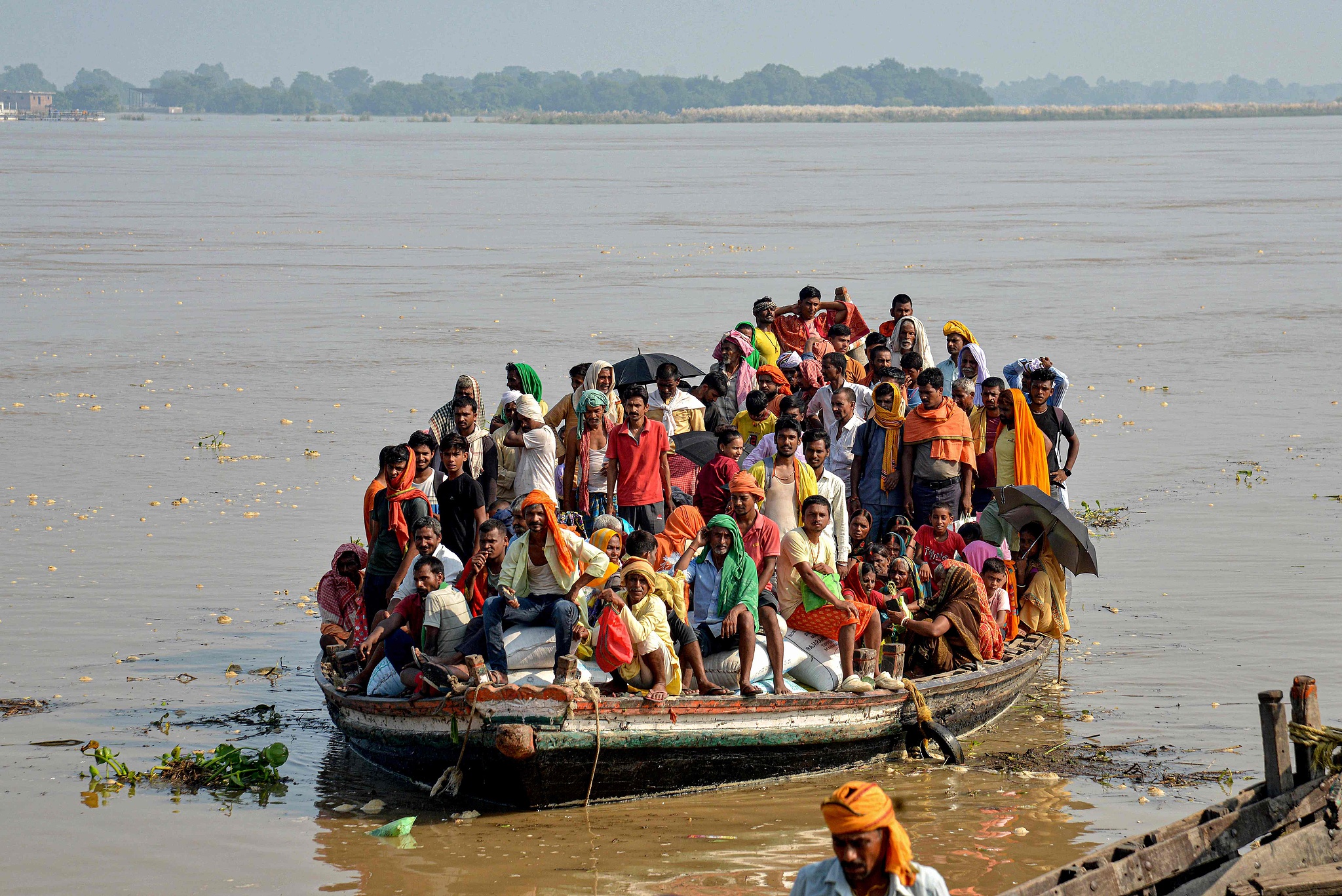 Flood-affected people move to a safer place in a boat after a rise in the water level of the river Ganges following heavy rains in Patna, India, September 23, 2024. /CFP