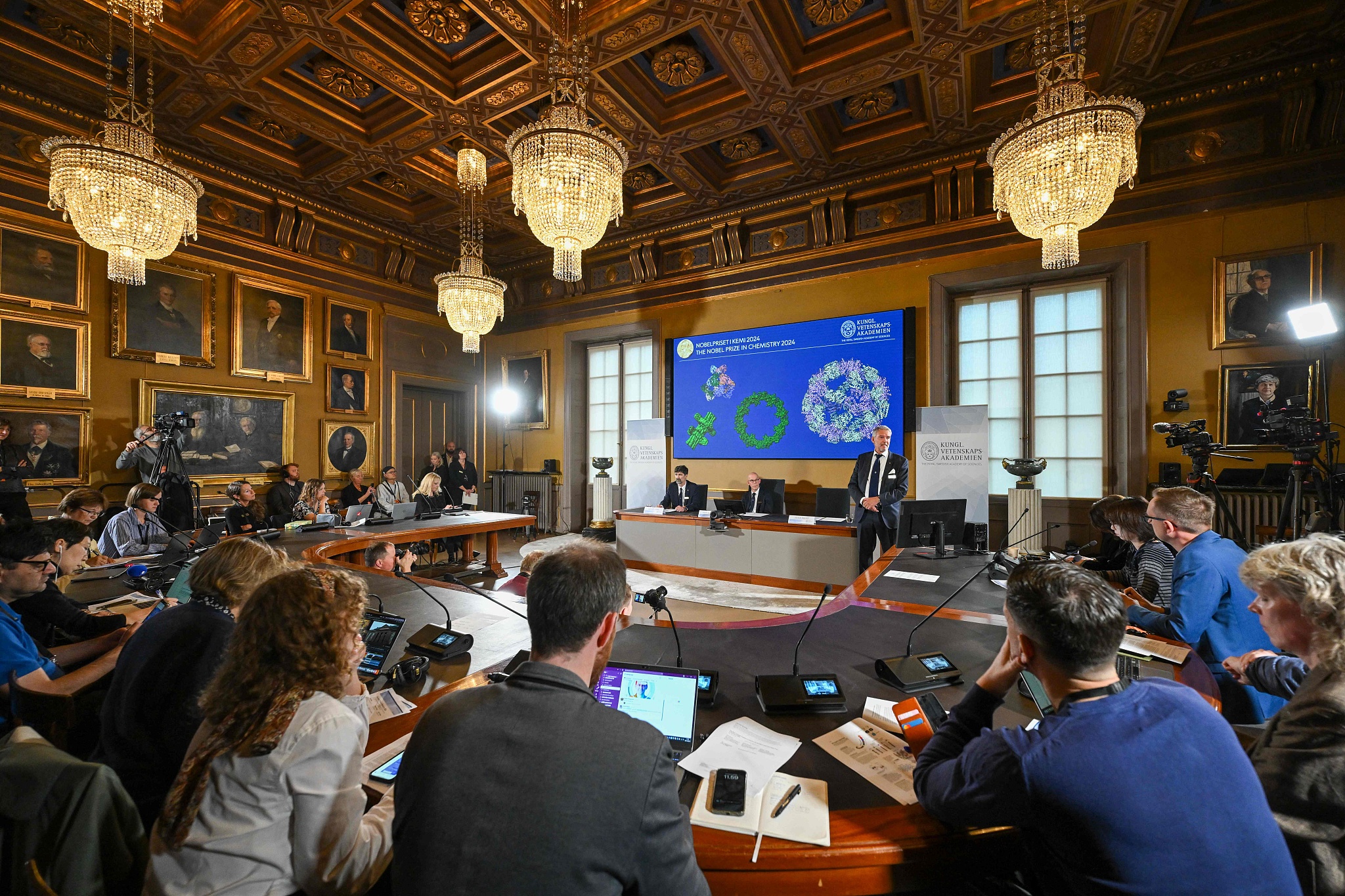 Heiner Linke, chair of the Nobel Committee for Chemistry at the Royal Swedish Academy of Sciences, the Secretary General of the Royal Swedish Academy of Sciences Hans Ellegren and member of the Nobel Committee for Chemistry Johan Aqvist explain the work of the winners of the 2024 Nobel Prize in Chemistry during the announcement by the Royal Swedish Academy of Sciences in Stockholm, Sweden, October 9, 2024. /CFP