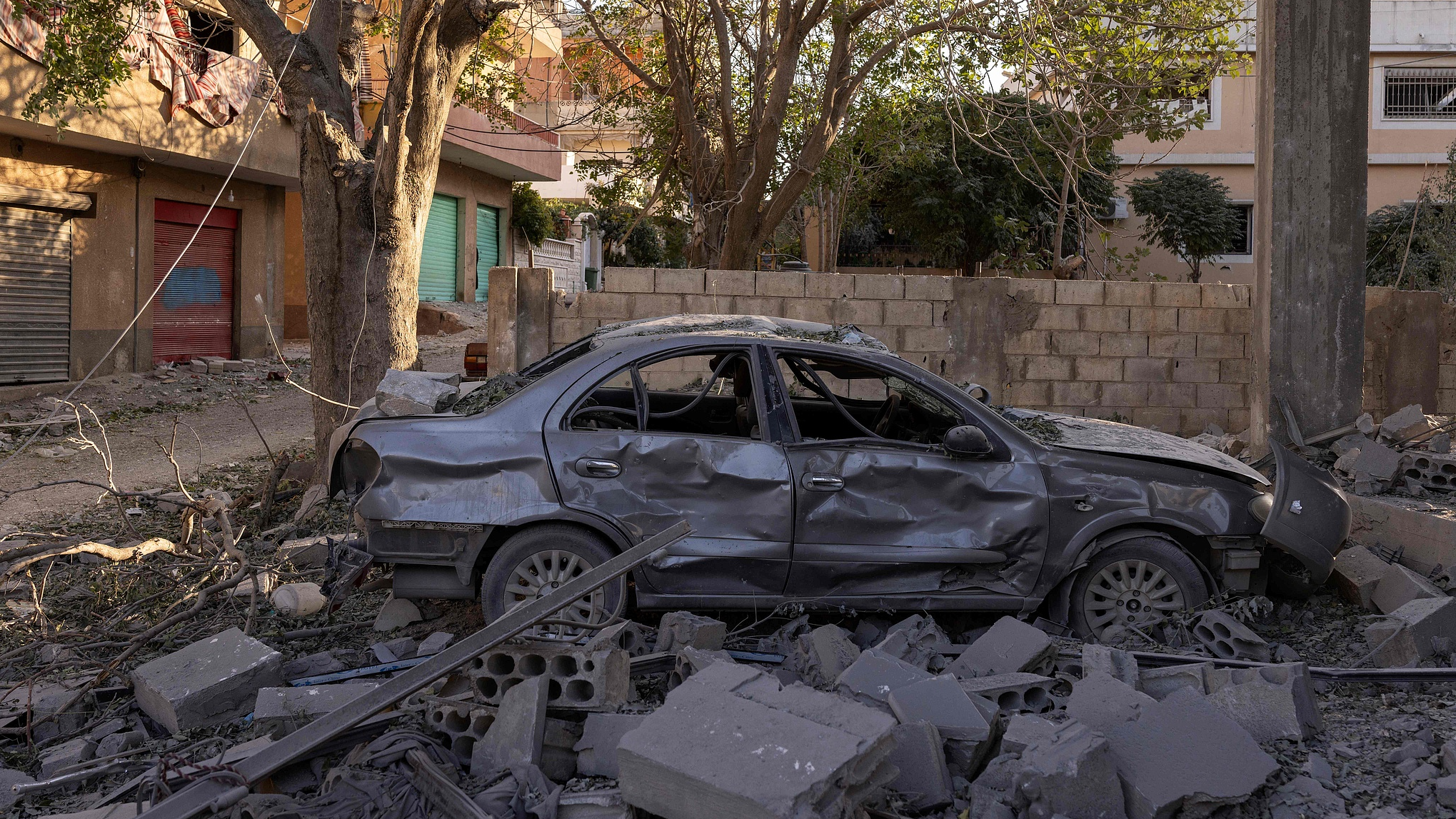 A car destroyed in an Israeli airstrike sits surrounded by debris in Baalbek, in Lebanon's eastern Bekaa Valley, October 9, 2024. /CFP