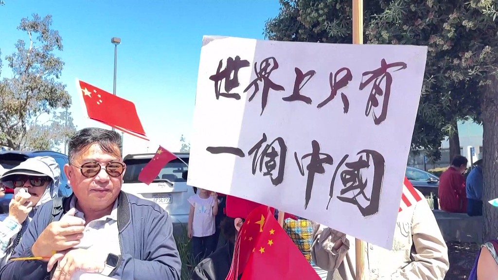 People hold their banner saying 