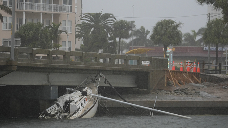 A boat damaged in Hurricane Helene rests against a bridge ahead of the arrival of Hurricane Milton in South Pasadena, Florida, U.S., October 9, 2024. /CFP