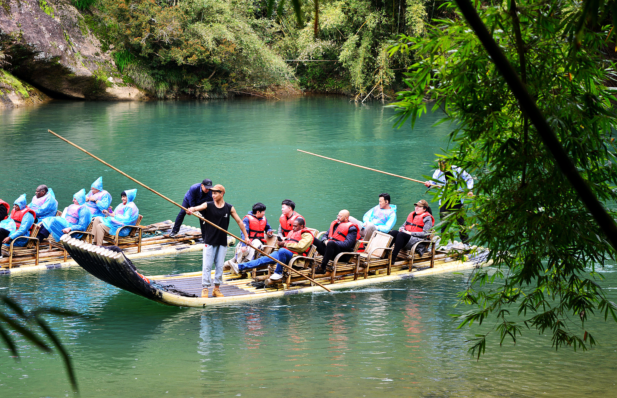 Tourists ride bamboo rafts along the Jiuqu Stream in Wuyi Mountain National Park, Nanping City, southeast China's Fujian Province, March 21, 2024. /CFP