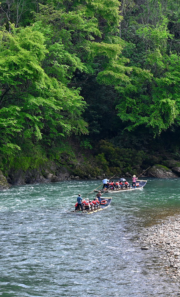 Tourists take a bamboo raft and drift down the river to experience the natural scenery at Wuyi Mountain National Park in Nanping, Fujian Province, April 10, 2024. /CFP