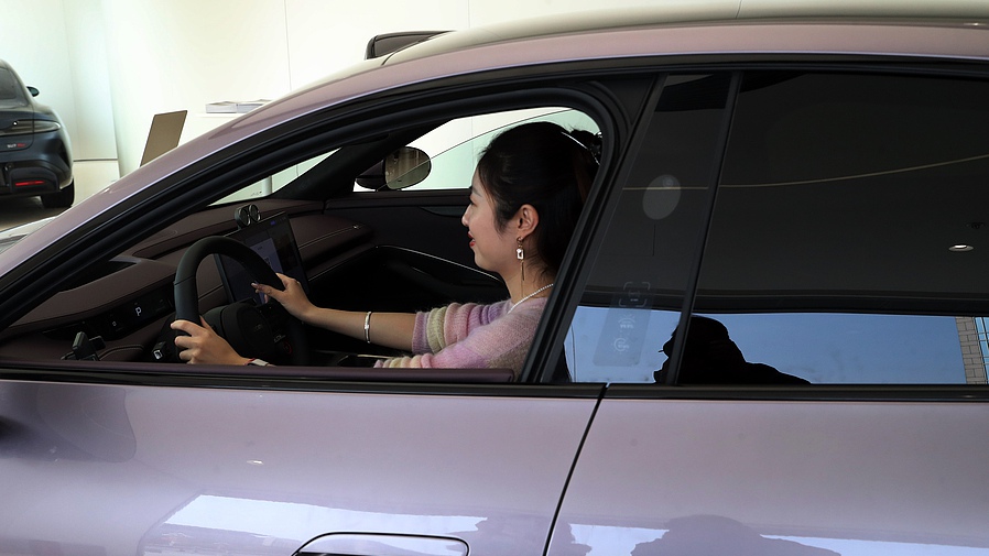 A customer takes a test drive at a local auto shop in Beijing, October 5, 2024. /CFP