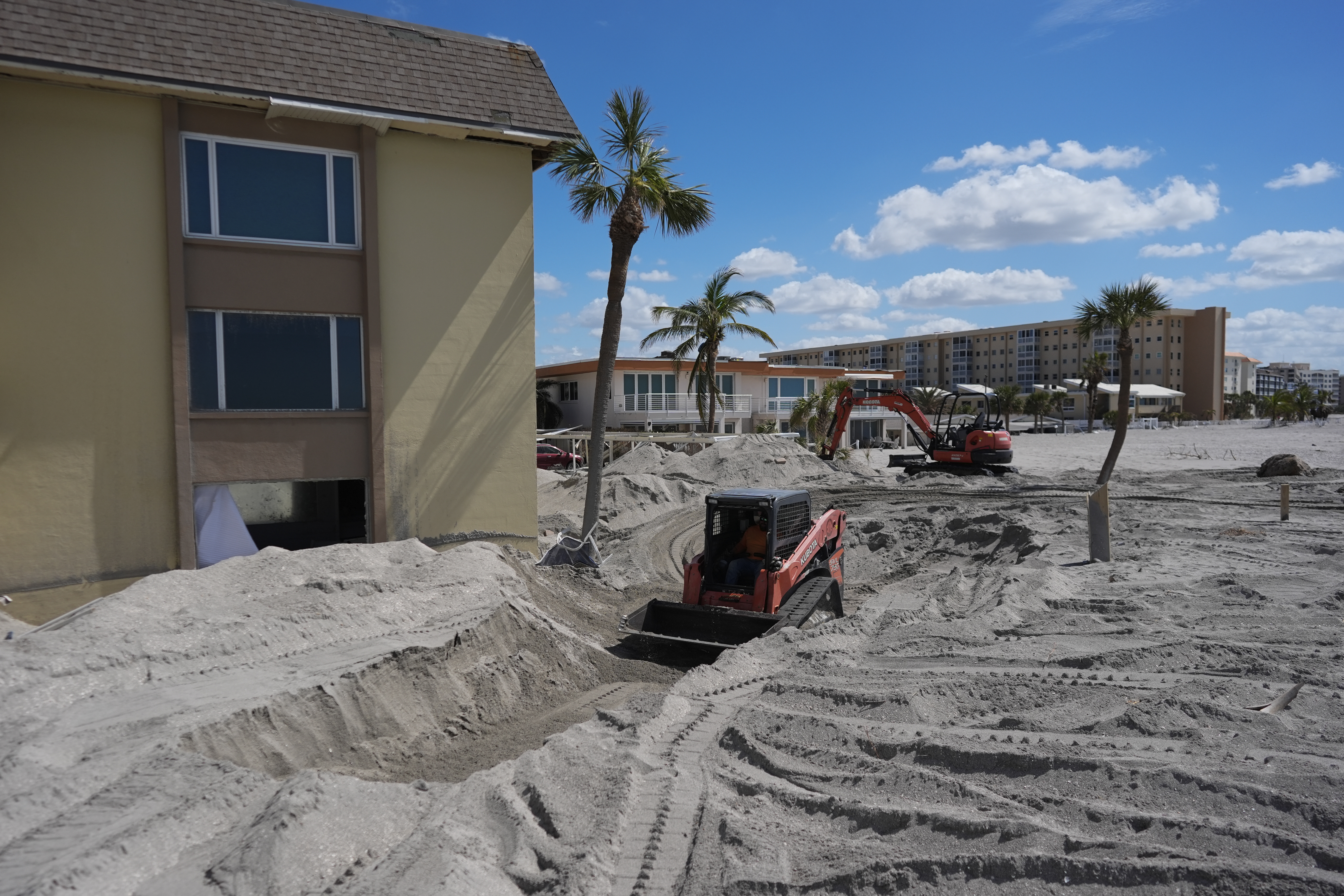 A skid steer removes sand from the patio of a beachfront condominium following the passage of Hurricane Milton, Venice, Florida, United States, October 12, 2024. /AP