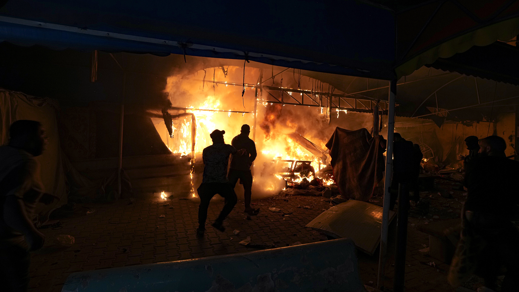 Palestinians react to a fire after an Israeli strike hit a tent area in the courtyard of Al Aqsa Martyrs hospital in Deir al Balah, Gaza, October 14, 2024. /CFP