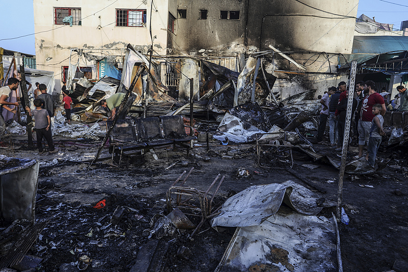 Palestinians pick through what is left of their tents, which were burned in an Israeli army strike on tents for displaced people inside the walls of Al-Aqsa Martyrs Hospital in Deir el-Balah in central Gaza, October 14, 2024. /CFP