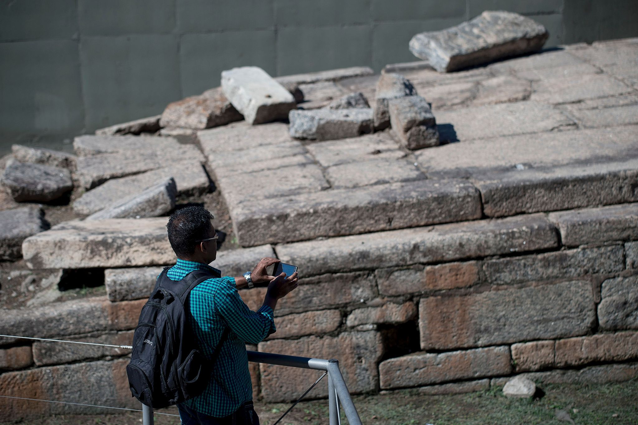 A visitor takes photos of the Valongo Wharf Archaeological Site in Rio de Janeiro, Brazil. /CFP