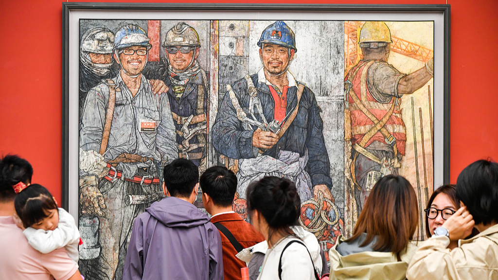 A photo taken on October 13, 2024 shows visitors appreciating an artwork on display at the National Art Museum of China in Beijing. /CFP