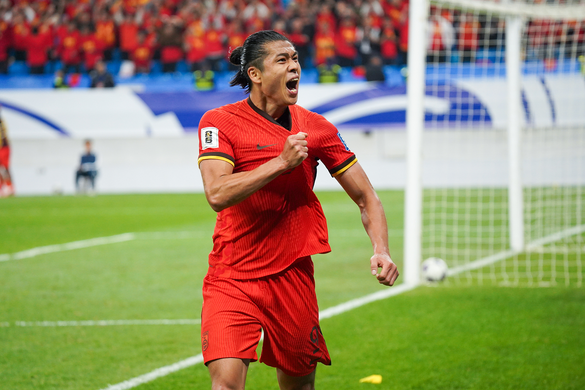 Zhang Yuning of China celebrates after scoring a goal against Indonesia in a 2026 FIFA World Cup Asian Football Confederation (AFC) Qualifying match in Qingdao, east China's Shandong Province, October 15, 2024. /CFP