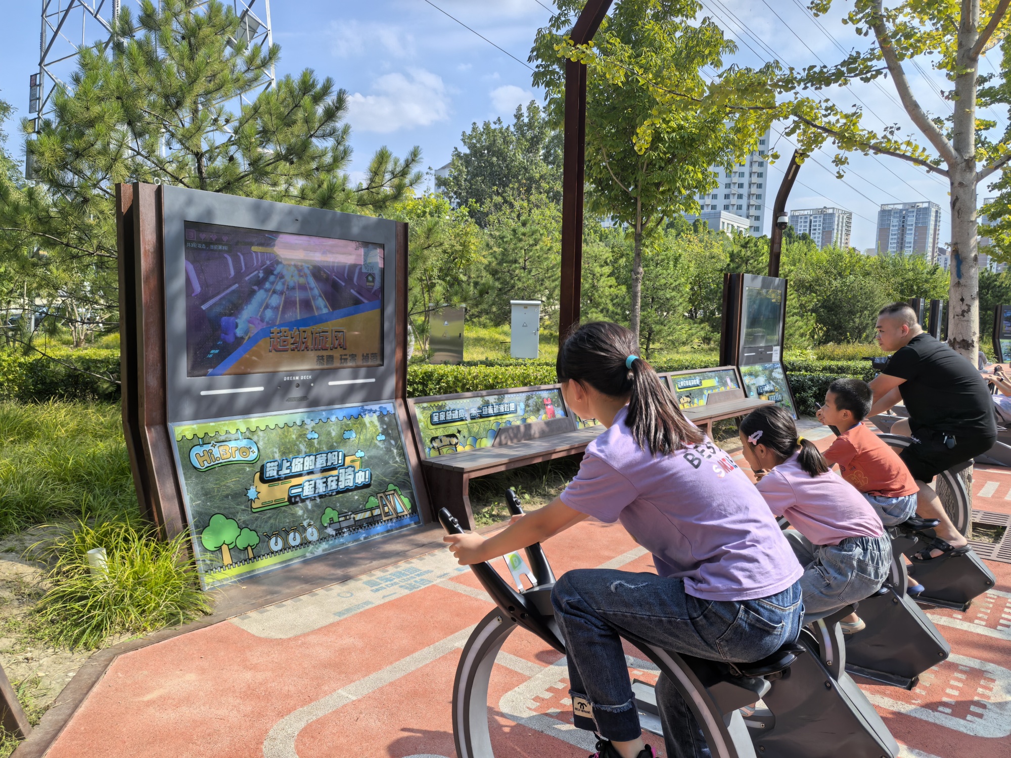 A man and children play fitness games with the help of AI at the Jingzhang Railway Park in Beijing on September 17, 2024. /CGTN