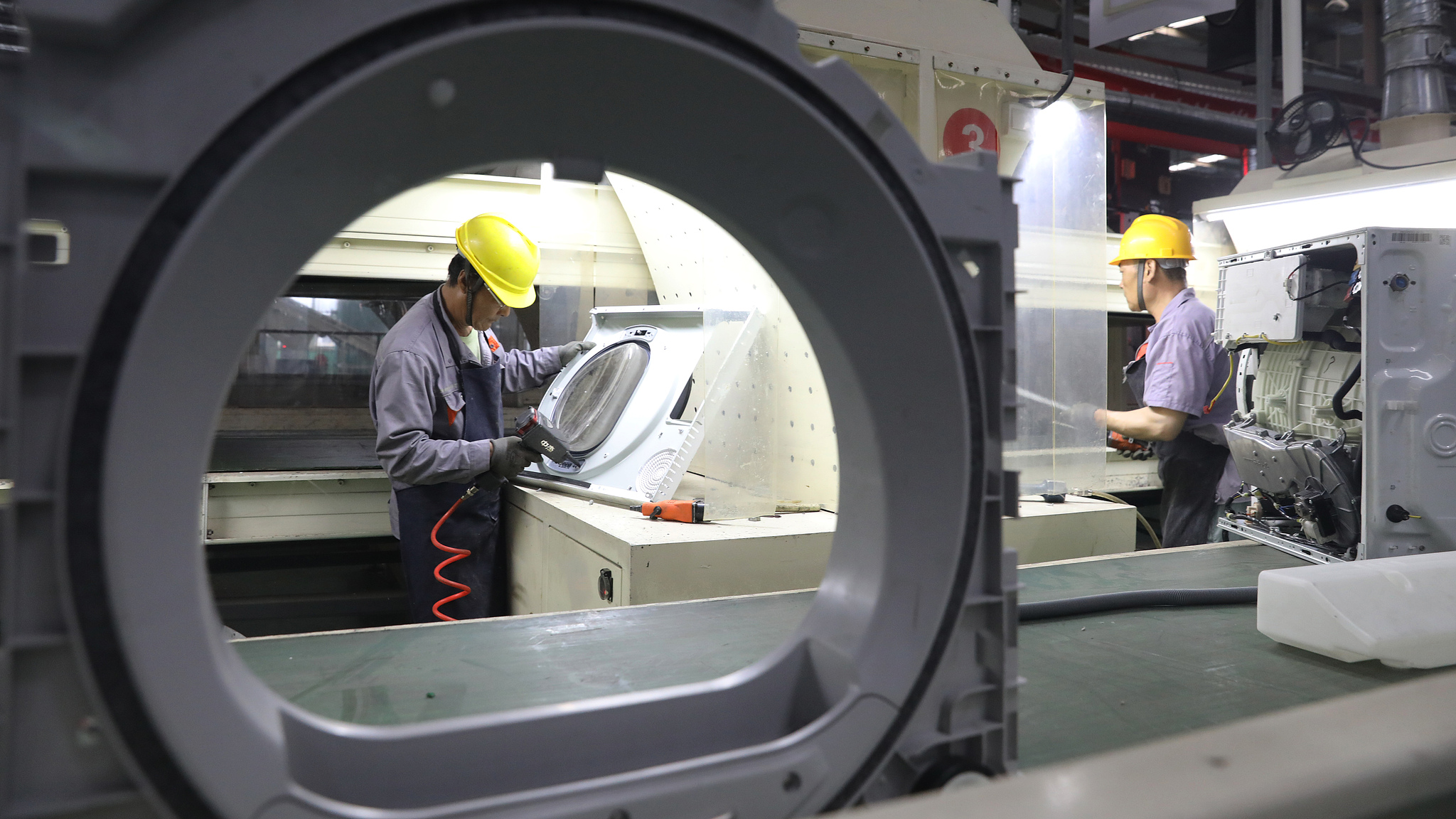 Workers disassemble recycled old appliances at a factory in Qingdao, east China's Shandong Province, July 3, 2024. /CFP