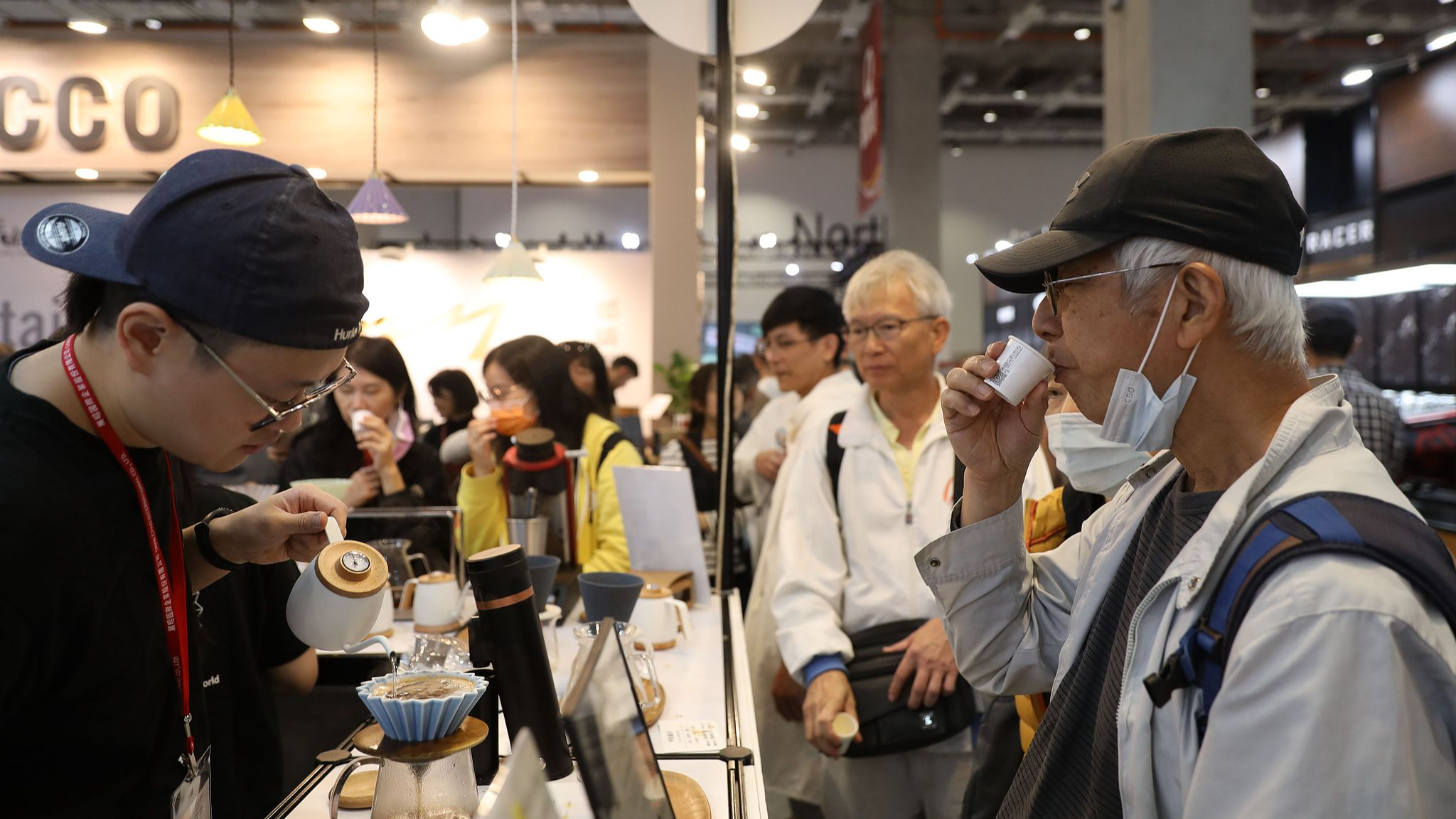 An elderly man tastes coffee at a coffee exhibition in Taipei City, China's Taiwan region, November 17, 2023. /CFP