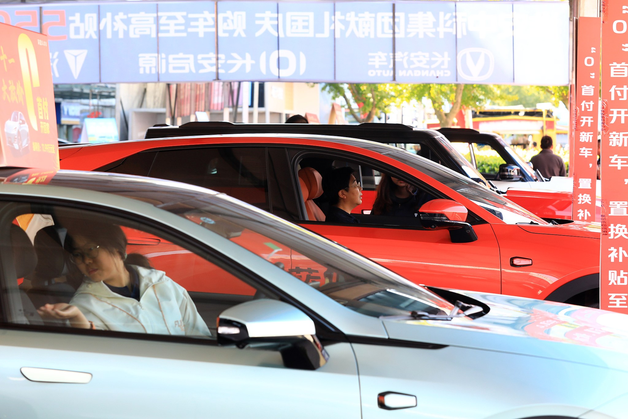 Consumers sit in new cars in Huaian City, Jiangsu Province, where the local government offers subsidies for those who trade in old cars for new ones, October 3, 2024. /CFP
