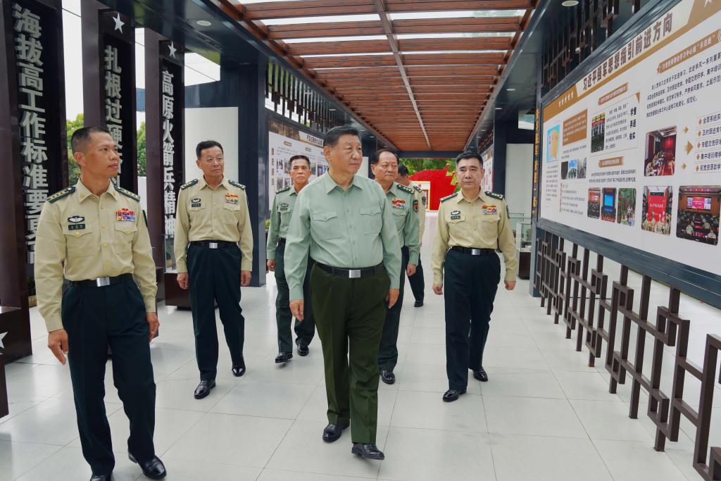 Chinese President Xi Jinping, also general secretary of the Communist Party of China Central Committee and chairman of the Central Military Commission, learns about the history of a brigade, October 17, 2024. Xi inspected a brigade of the Chinese People's Liberation Army Rocket Force on Thursday. /Xinhua