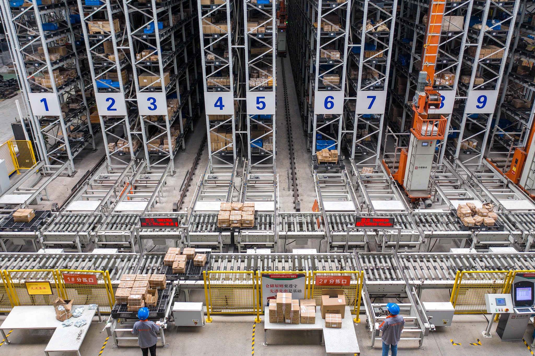 Technicians operate an intelligent warehouse at an intelligent equipment company in Changxing Economic and Technological Development Zone of Huzhou City, east China's Zhejiang Province, June 16, 2021. /CFP