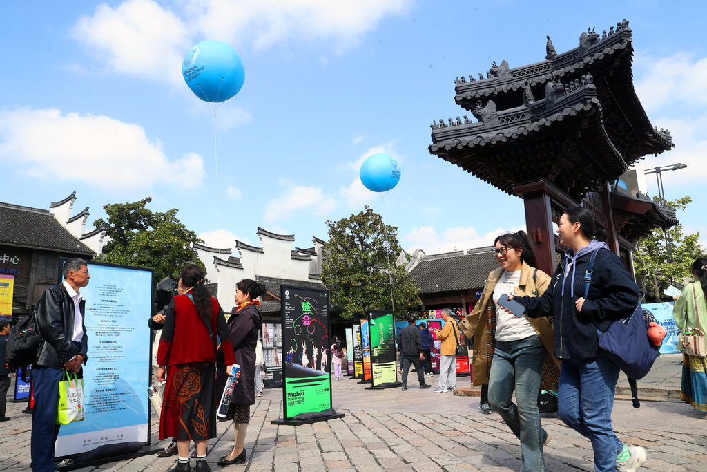 Tourists flock to Wuzhen water town in Jiaxing, Zhejiang Province, to soak up the autumn scenery on October 20, 2024. /CFP