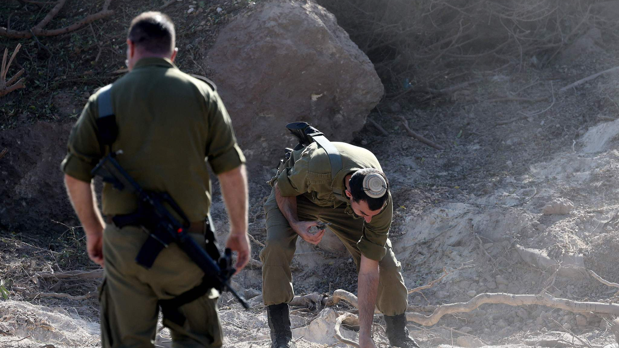 Israeli soldiers gather debris from the site of a rocket attack, fired from Lebanon, in Kibbutz of Maagan Michael, south of Haifa, October 22, 2024. /CFP