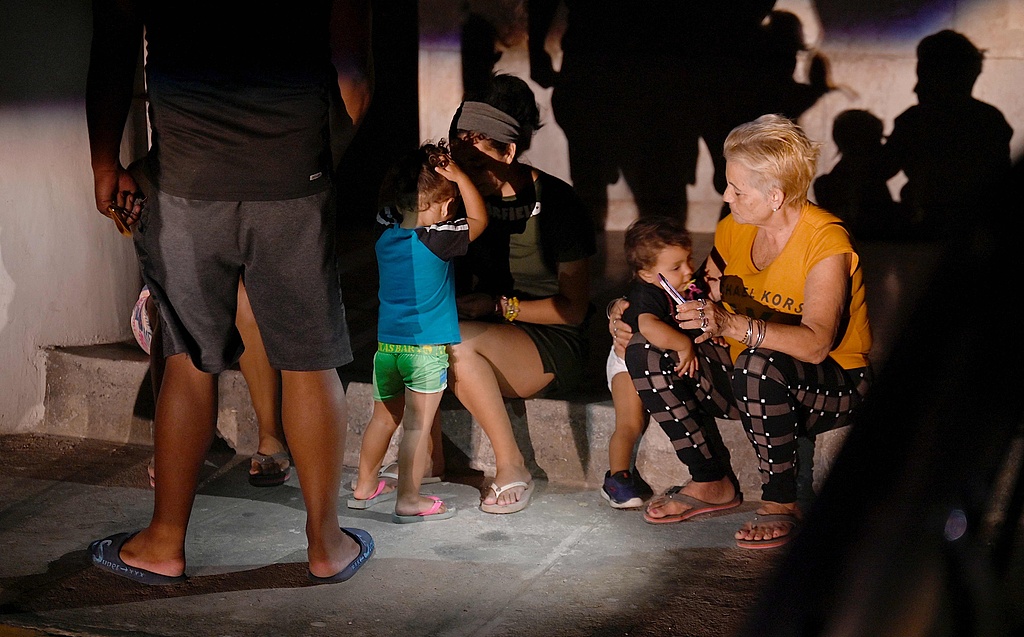 People wait on the street during the third night of a nationwide blackout, Havana, Cuba, October 20, 2024. /CFP