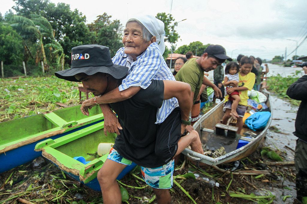 An elderly woman is evacuated to safer ground in Bato town, Camarines Sur province, south of Manila, Philippines, October 23, 2024. /CFP