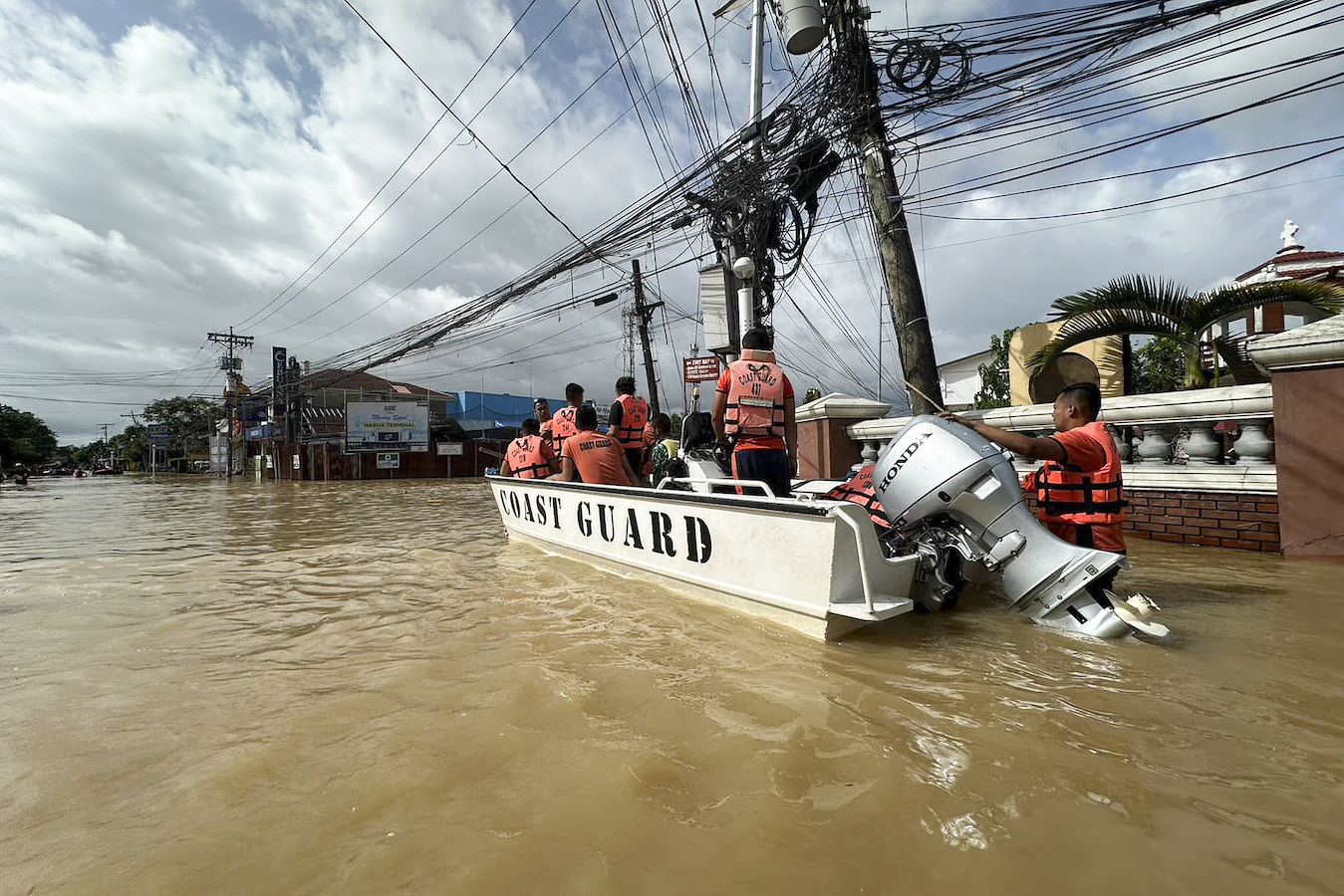 Rescuers ride a boat around the flooded town of Nabua, Camarines Sur, the Philippines on Friday Oct. 25, 2024. /CFP