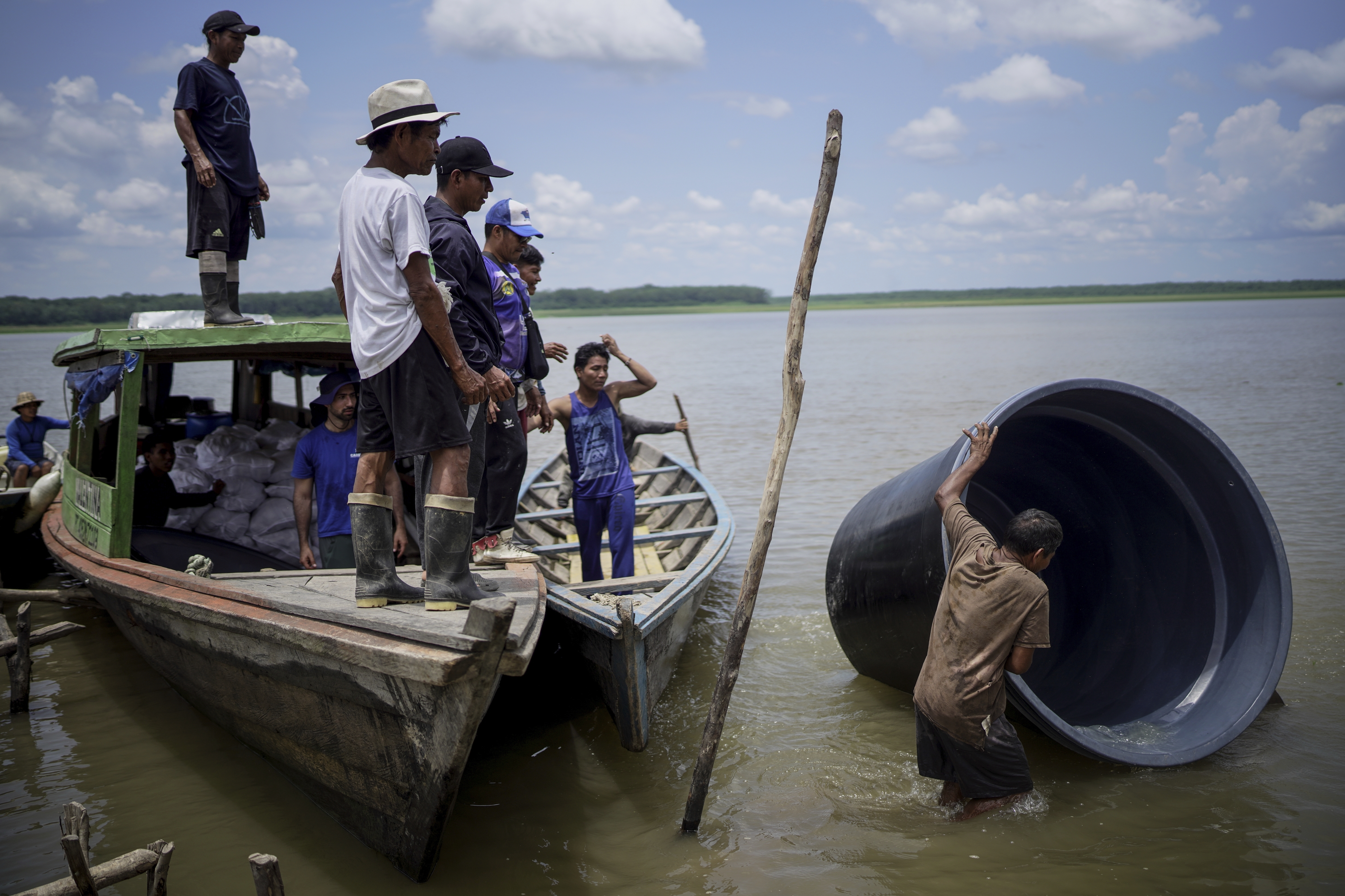 A man from the Tikuna Indigenous community carries a cistern from a nonprofit that can be used to catch and store rainwater for the community amid a drought in Loma Linda, near Leticia, Colombia, October 20, 2024. /AP