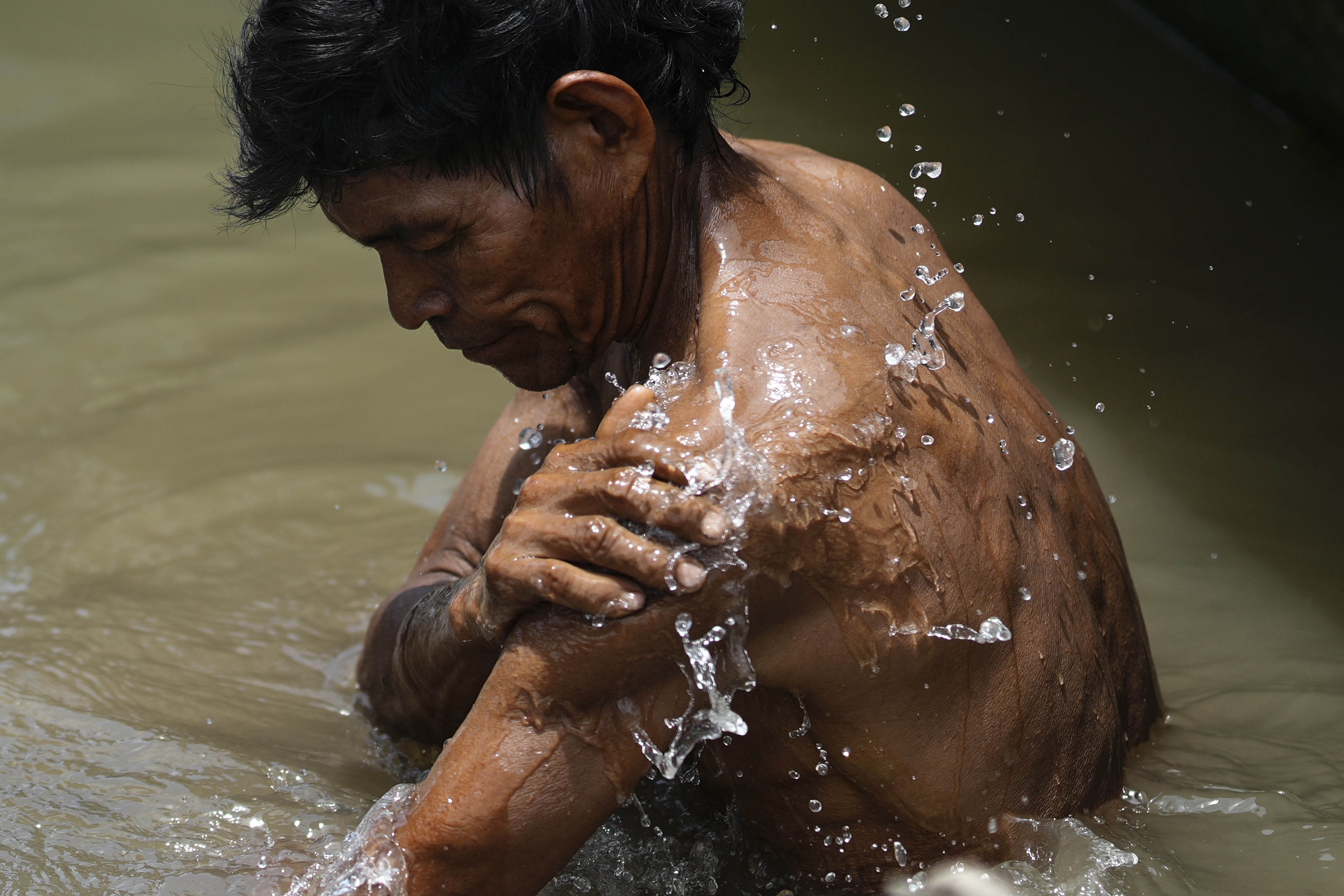 An Indigenous man from the Tikuna community bathes in the Amazon River, in Loma Linda, Colombia, October 20, 2024. /AP