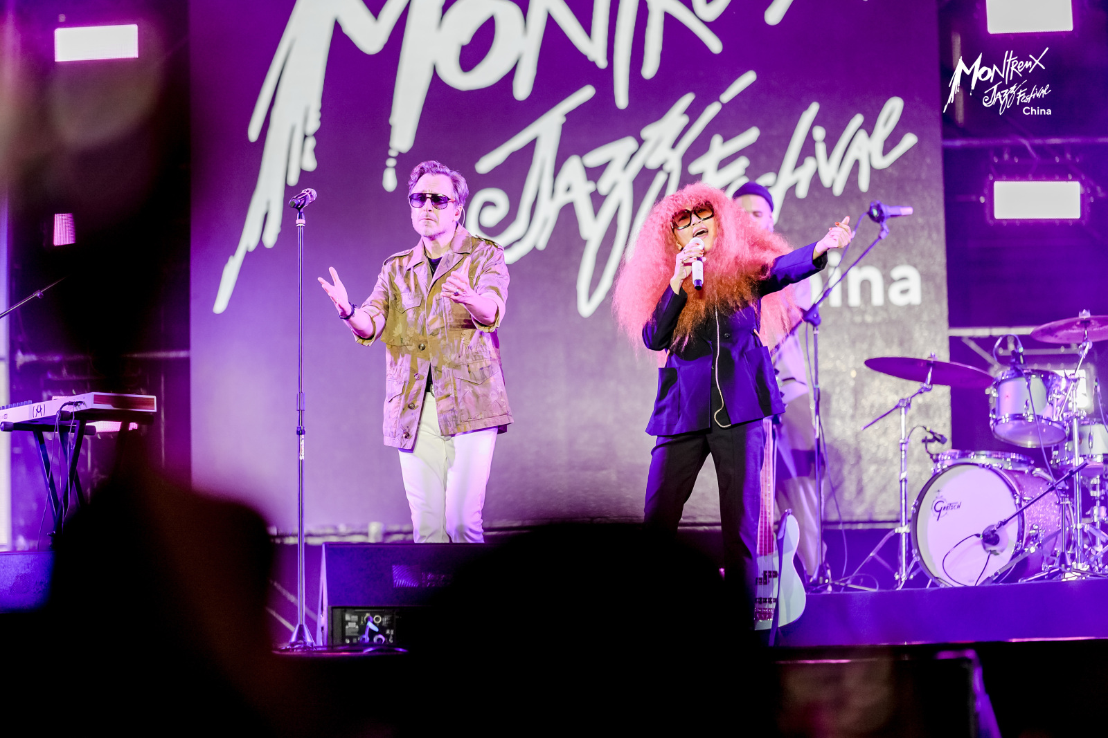 Zhang Qiang (right), the Chinese Disco Queen, and the rock band Stevans from Switzerland take the stage together, pushing the atmosphere to a climax in the drizzle at the opening ceremony of the Montreux Jazz Festival China on October 25, 2024. /Photo provided to CGTN