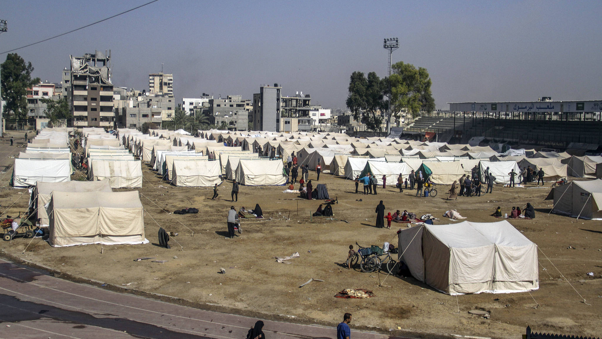 Hundreds of families fleeing Israel's attacks in northern Gaza shelter in a tent camp established at Yarmouk Stadium, Gaza, October 26, 2024. /CFP