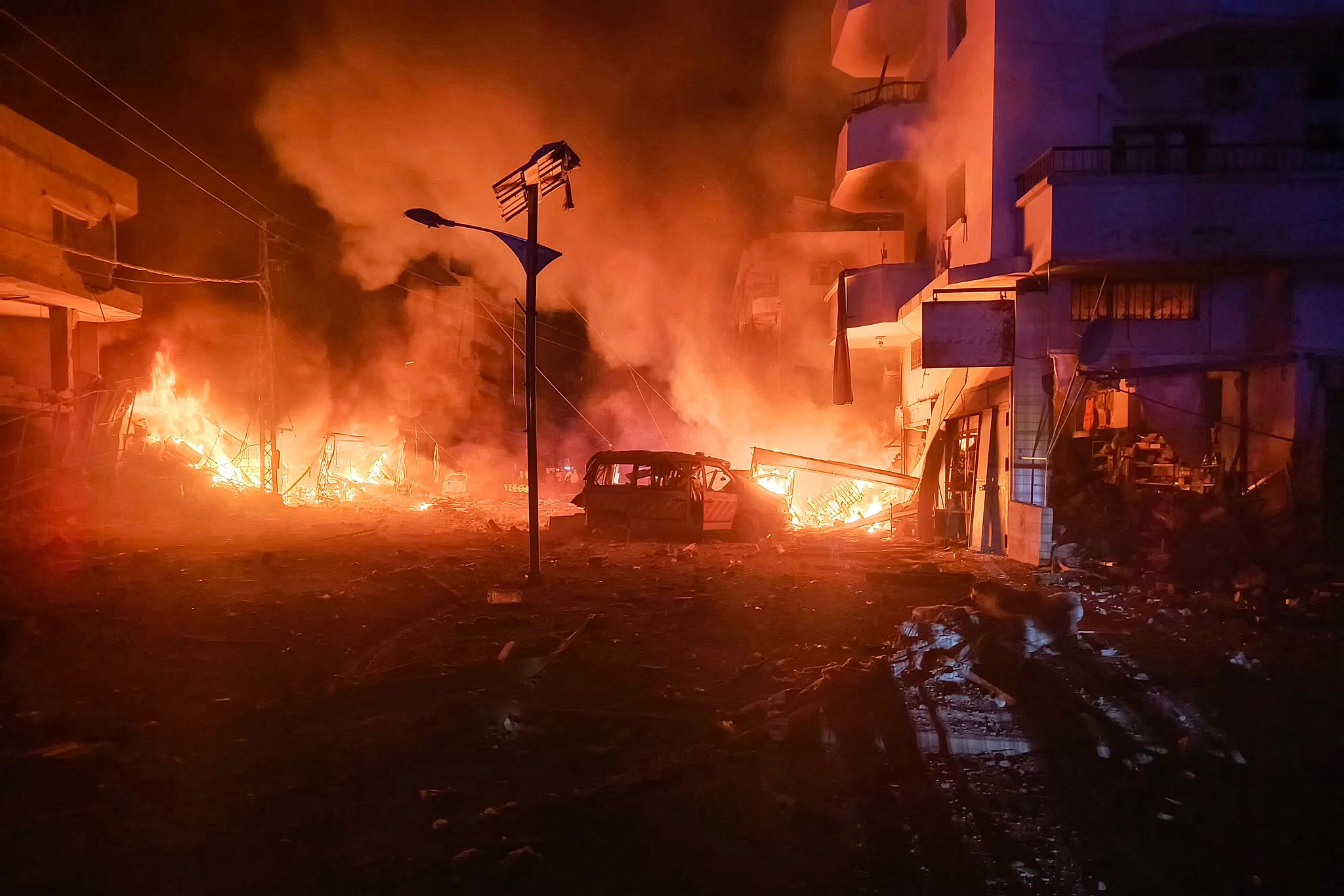 A damaged ambulance lies amid a fire following an Israeli air strike that targeted the industrial zone in the southern Lebanese village of Abbasiyeh near Tyre as fighting between Israel and Hezbollah continues, October 30, 2024. /CFP