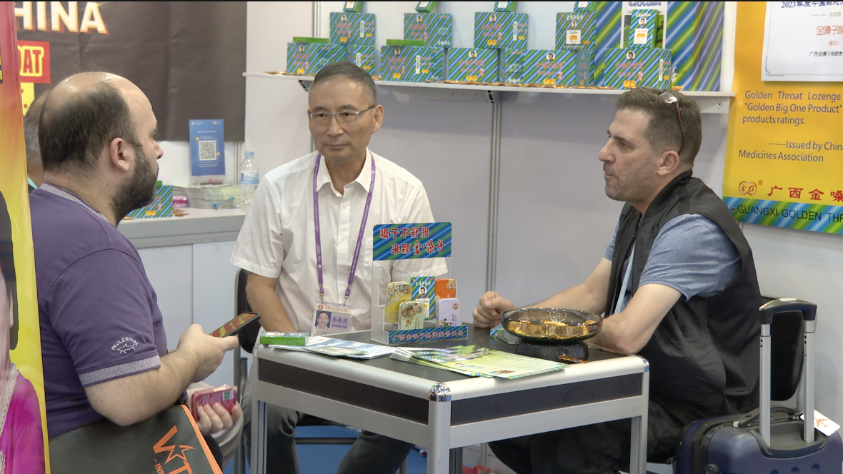 Wang Jinhui, manager at Guangxi Golden Throat Group, holds business talks with international buyers at the 136th Canton Fair, Guangdong Province, China, October 31, 2024. /CGTN