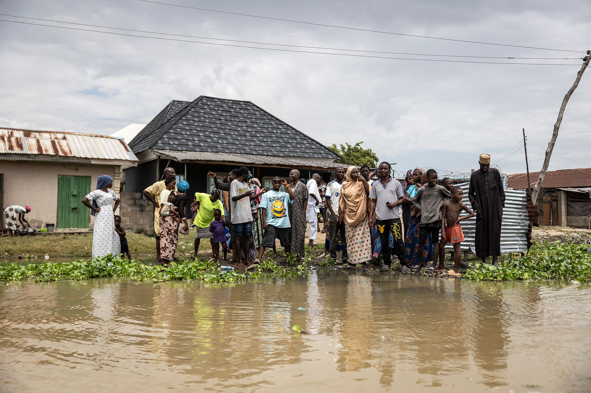 Residents stand on a clearing in the flooded Adankolo district in Lokoja, Nigeria, October 21, 2024. /CFP