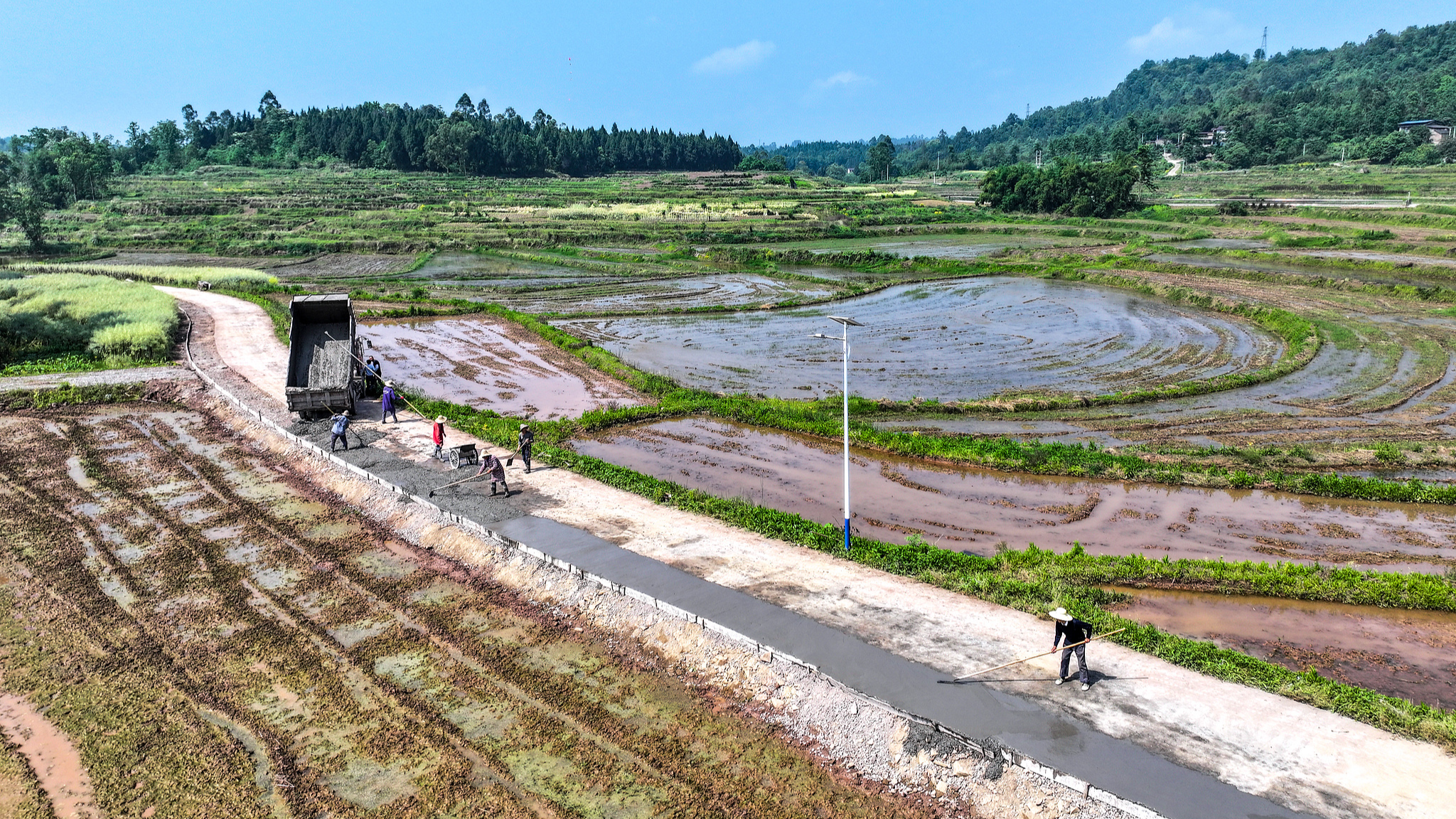 Villagers work on the construction site of a road renovation project in Jiangjun Village, Guangan City, southwest China's Sichuan Province, on April 26, 2024. The renovation project is part of a work-relief program. /CFP
