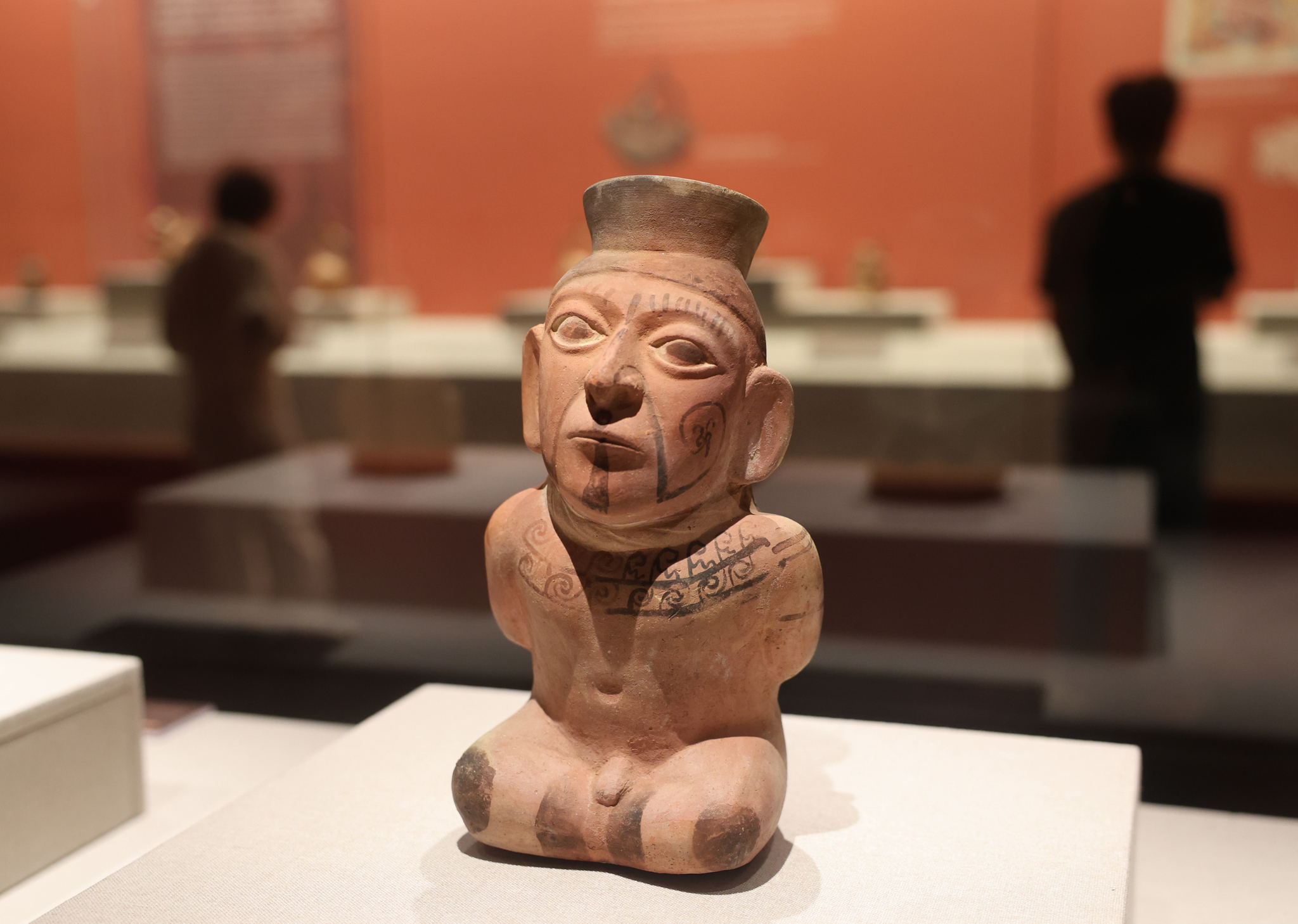 A ceramic vessel in the shape of a captive warrior is on display at 