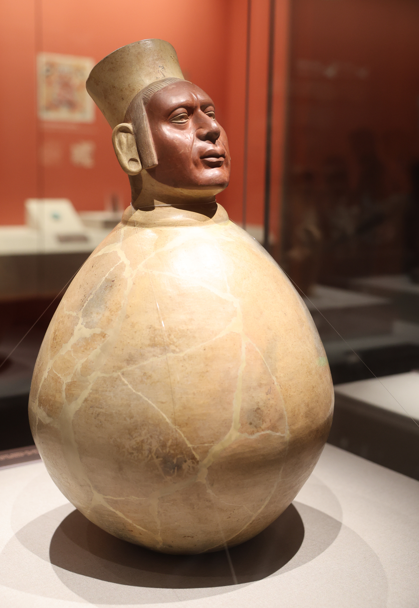 A pot featuring a human head is on display at 