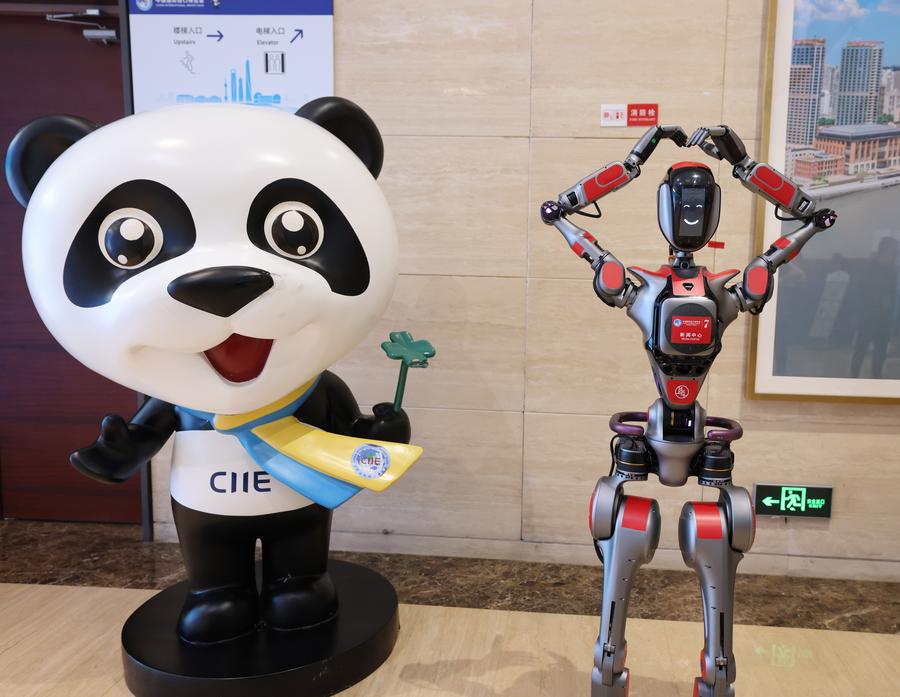 Jinbao, the mascot of the China International Import Expo (CIIE), and Xiaoxin, a humanoid robot providing an inquiry service, are pictured at the media center of the 7th CIIE in Shanghai, east China, November 4, 2024. /Xinhua