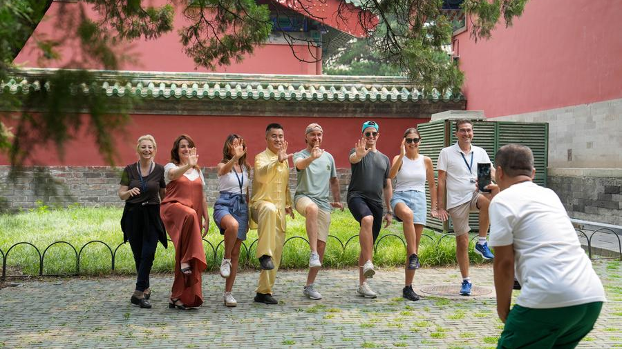 Tourists from Italy pose for a group photo after practicing Tai Chi at the Tiantan (Temple of Heaven) Park in Beijing, capital of China, July 9, 2024. /Xinhua