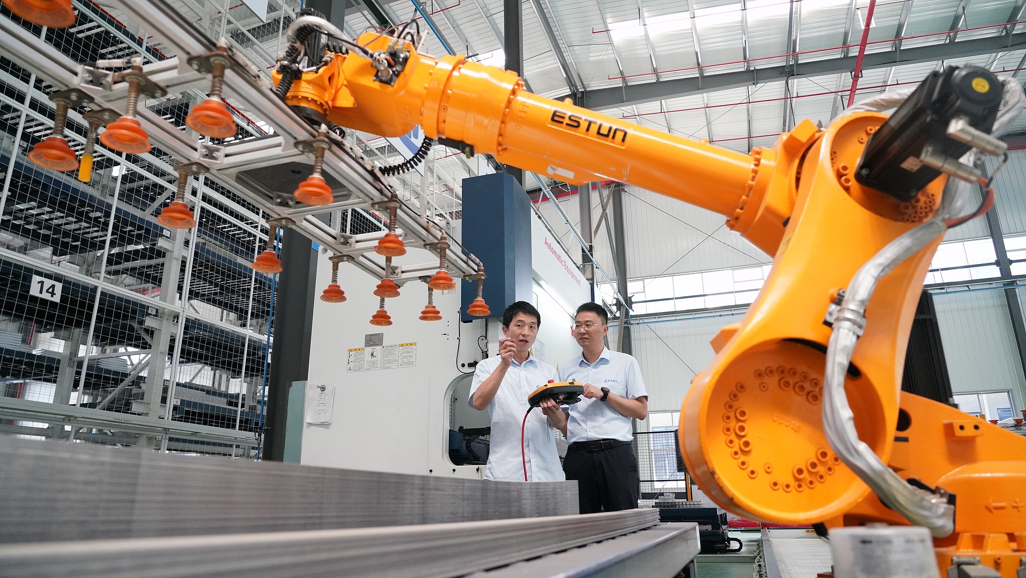 Workers operate the intelligent robotic arm at a smart workshop in Wuhan, central China's Hubei Province, August 26, 2024. /CFP