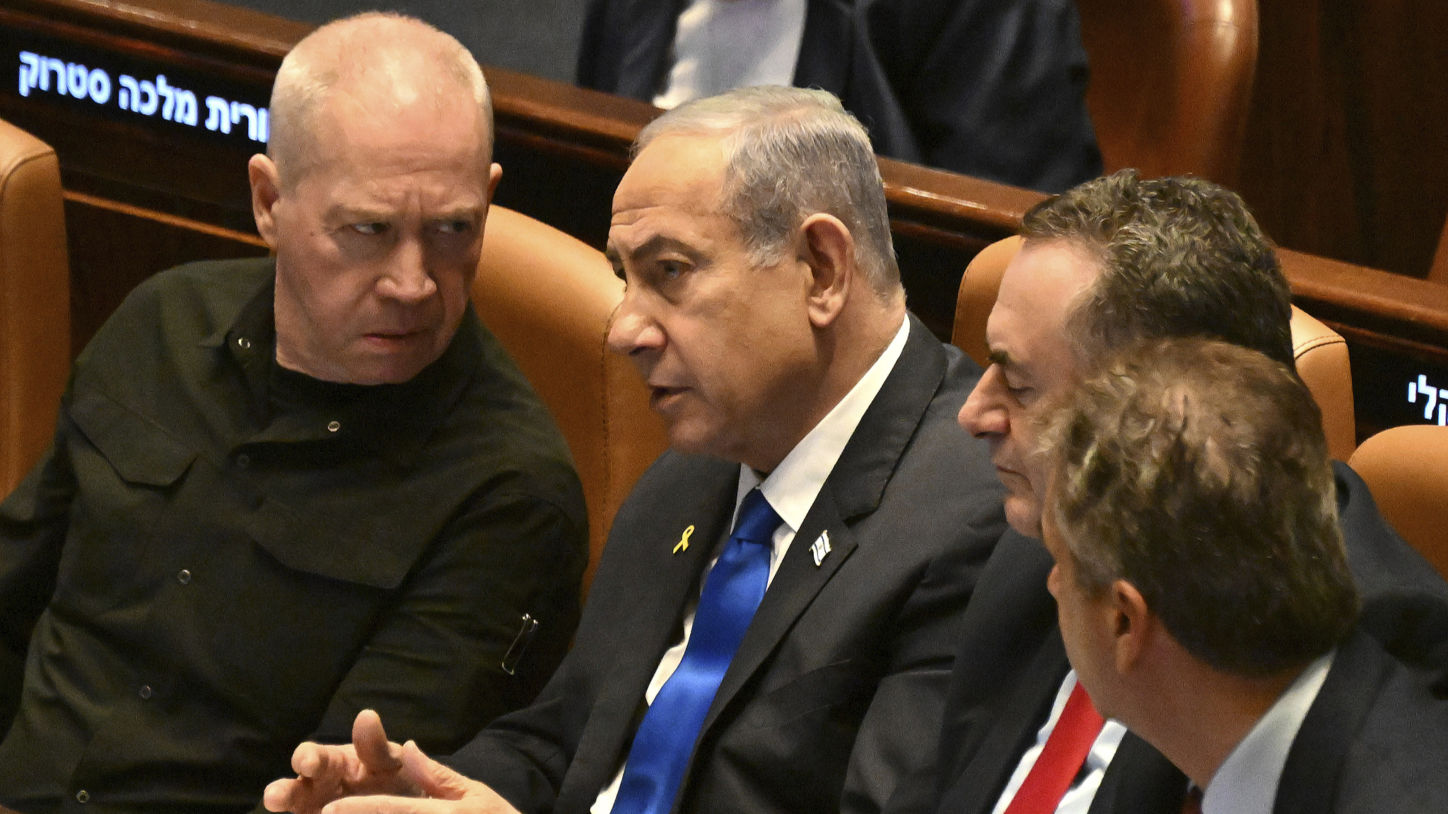 Israeli Prime Minister Benjamin Netanyahu (C) speaks to Defense Minister Yoav Gallant (L) at the opening of the 25th Knesset session in Jerusalem, October 28, 2024. /CFP