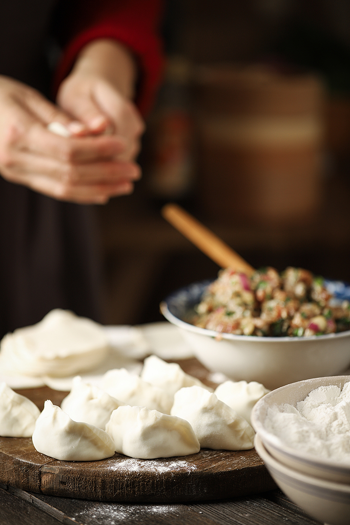 An undated photo shows a person making dumplings. /CFP