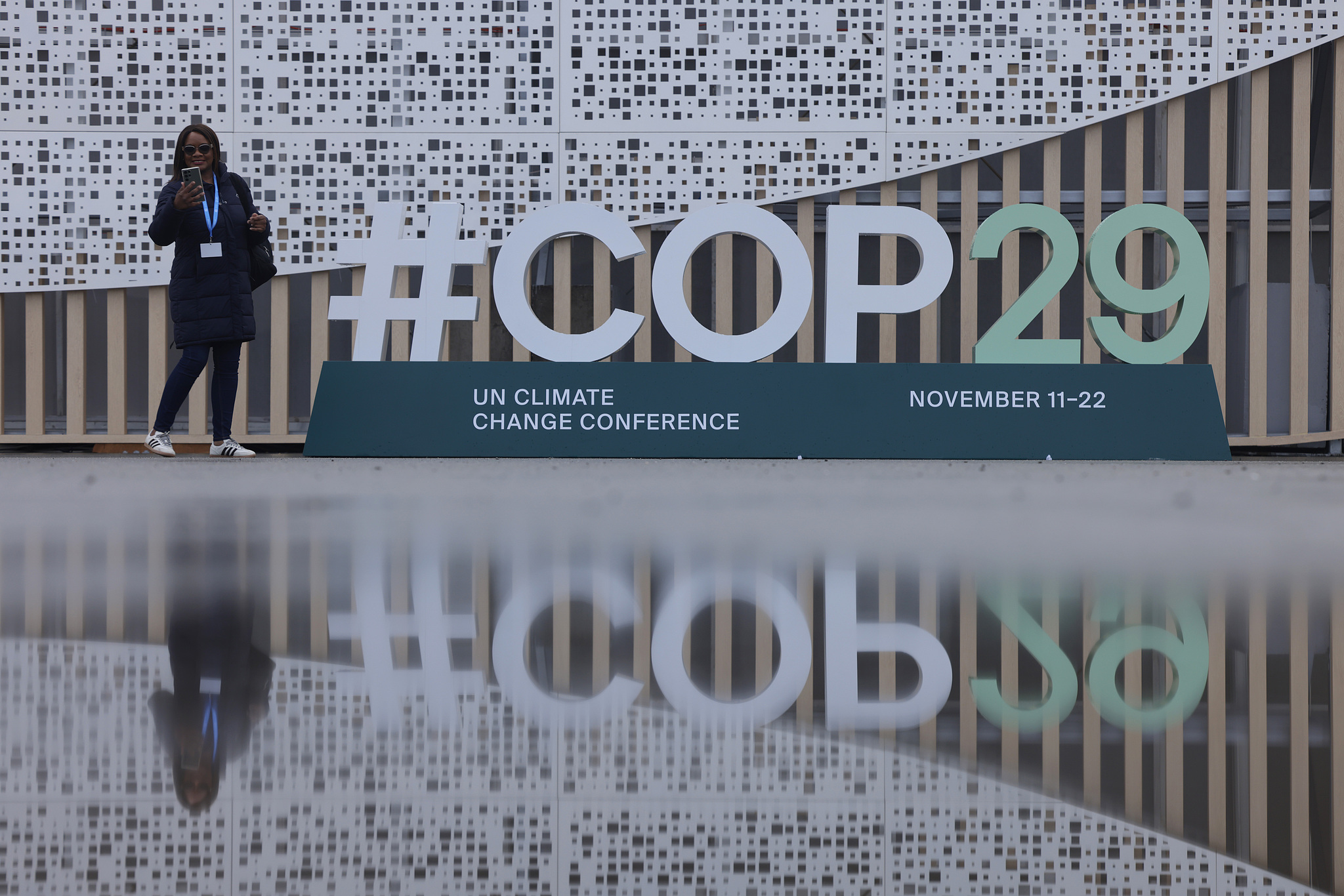 A participant stands next to the #COP29 hashtag ahead of the UN Climate Change Conference in Baku, Azerbaijan, November 9, 2024. /CFP