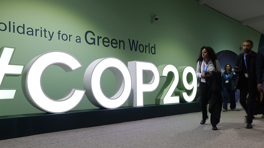 Participants walk past the COP29 hashtag on the opening day of the United Nations Climate Change Conference, Baku, Azerbaijan, November 11, 2024. /CFP